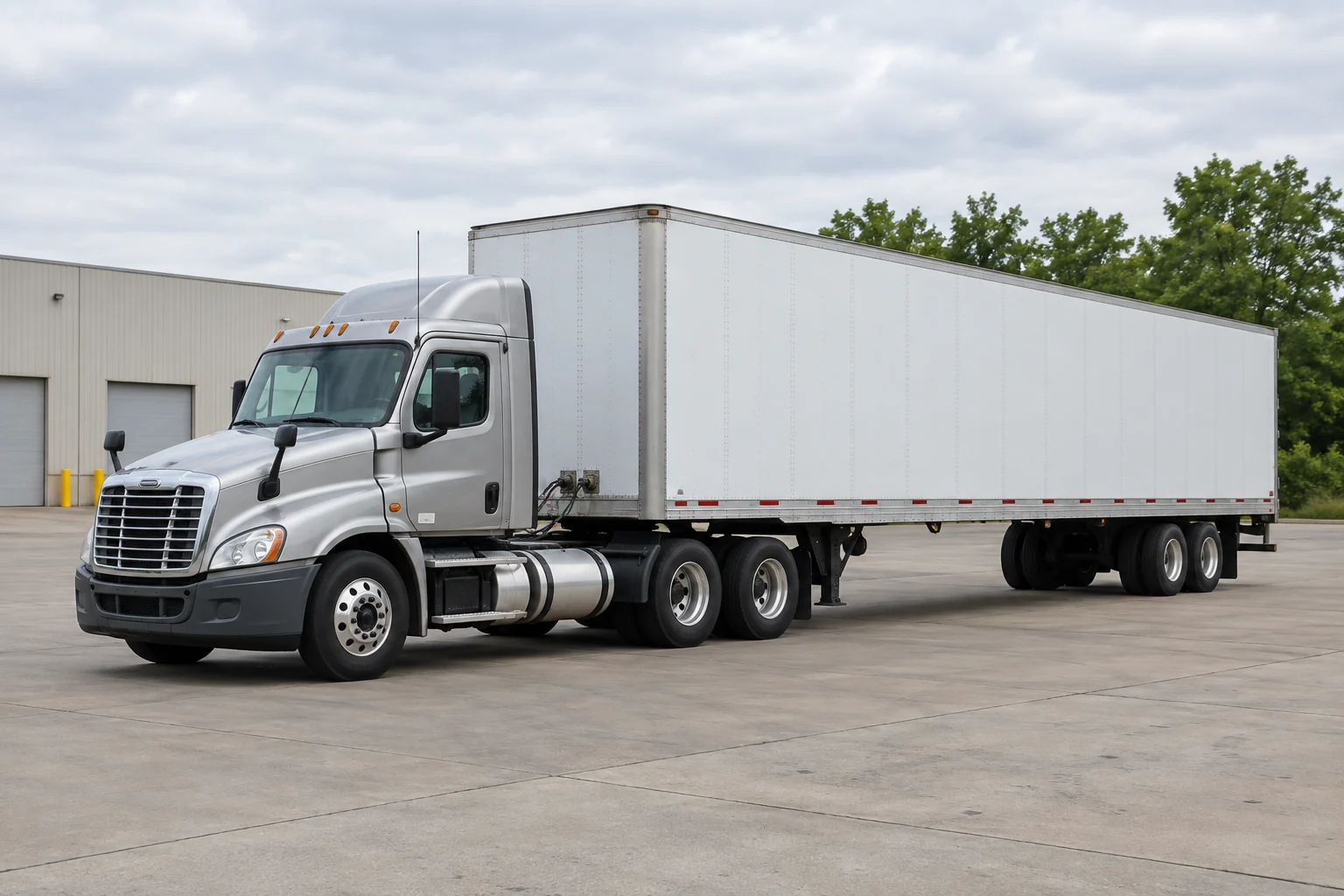 Silver tractor and dry-van trailer on a flat Indiana industrial yard
